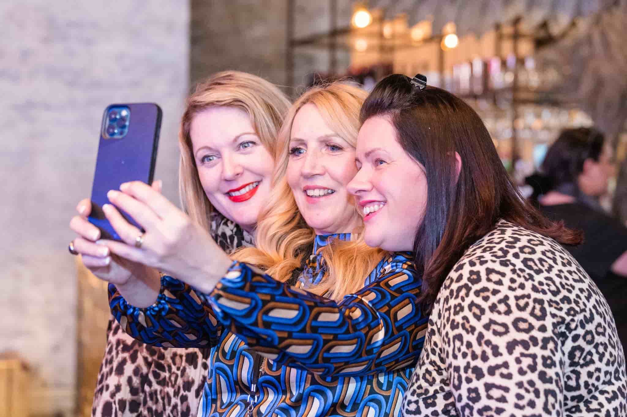 Women smiling, taking a selfie at a Peakes Private Members Club Event